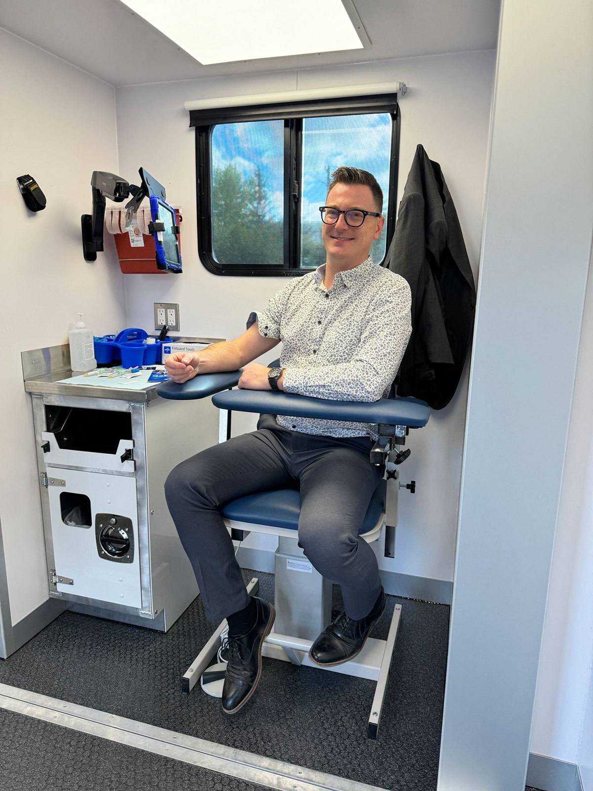 Person seated inside the MAN VAN® mobile clinic.