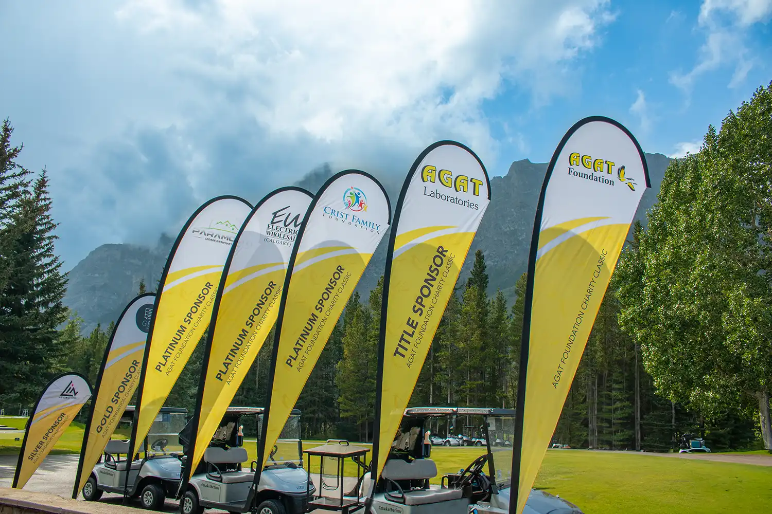 Sponsor flags at the AGAT Foundation Charity Classic golf tournament in Kananaskis, Alberta.