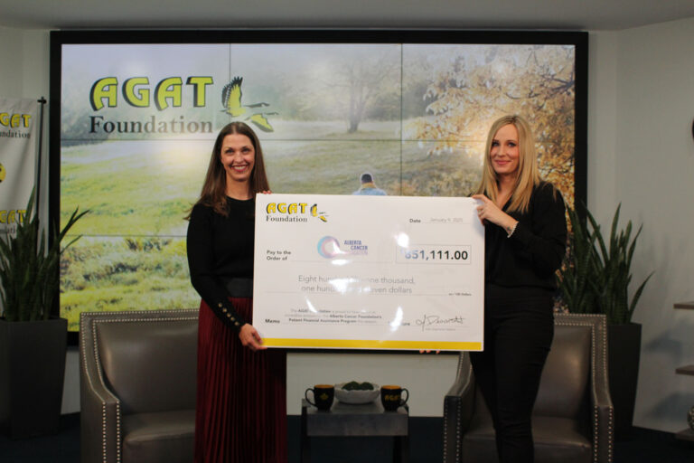 AGAT Foundation donation presentation with CEO Marissa Reckmann holding a large cheque alongside another representative.