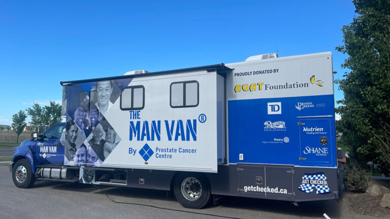 The MAN VAN™ mobile clinic sponsored by the AGAT Foundation parked outdoors under a clear blue sky.